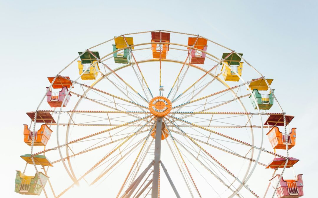worm's eye view of red, orange, and yellow Ferris wheel
