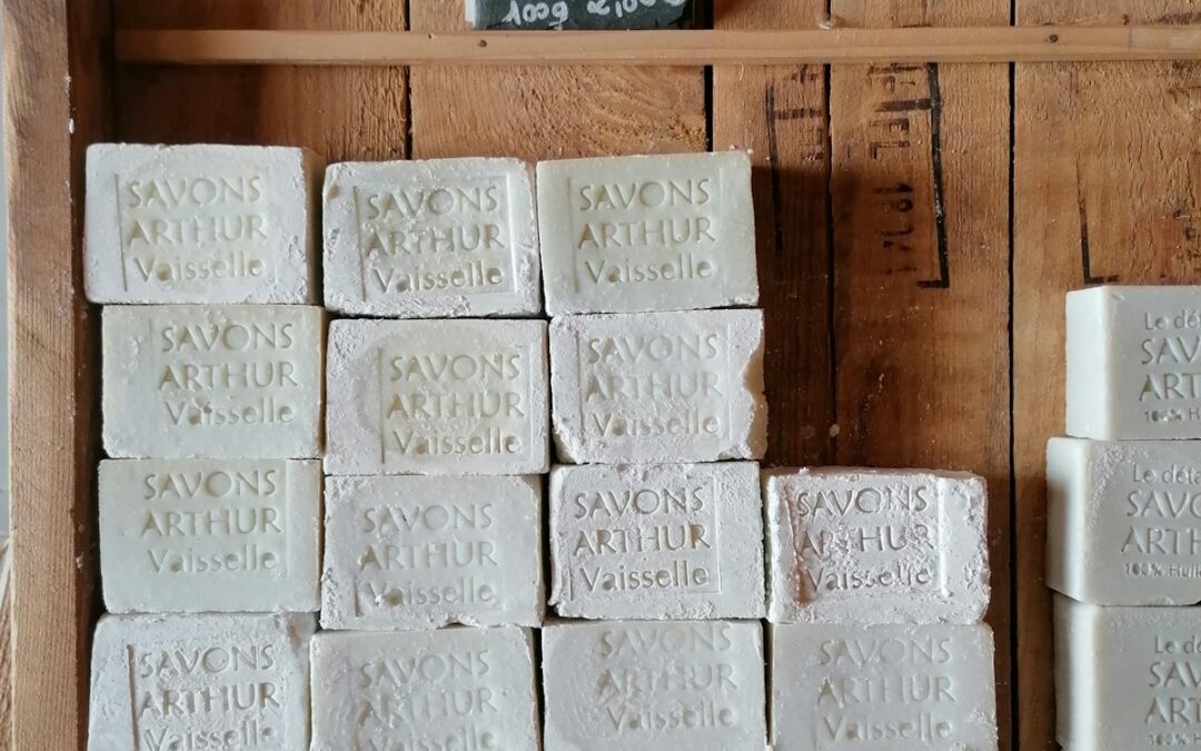 a wooden shelf filled with lots of white tiles