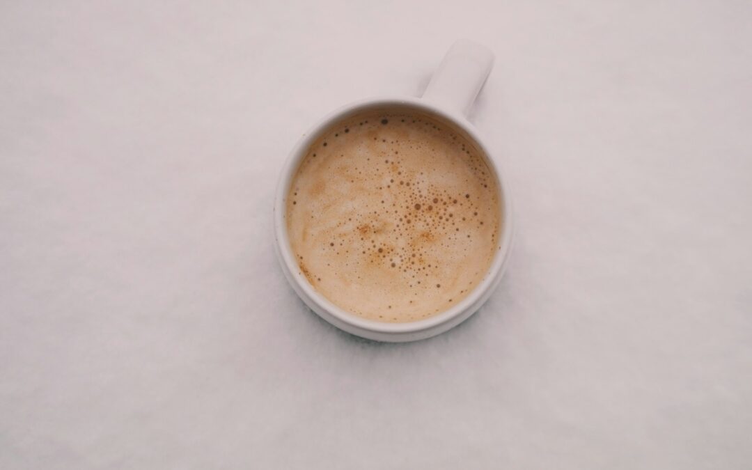 white cup with beverage