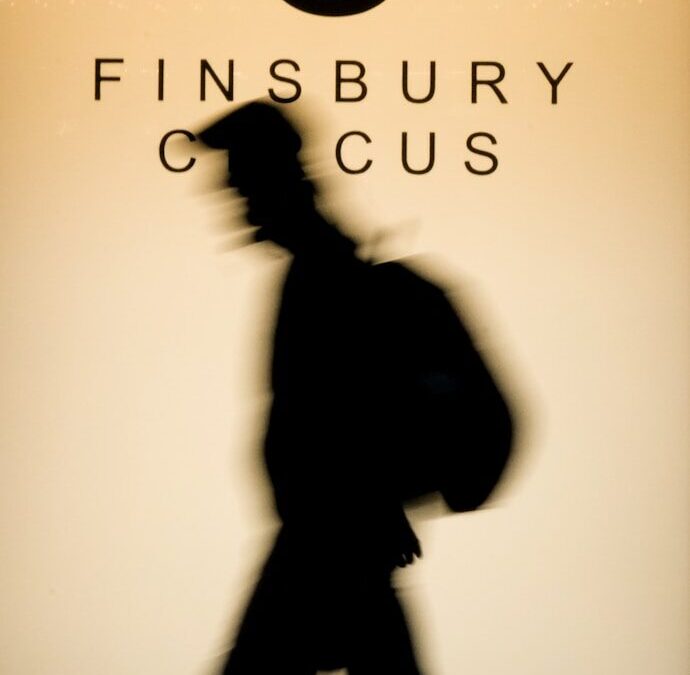 Silhouette of person walking past sign with number eight